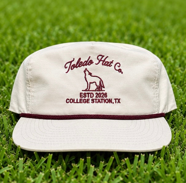 Toledo Hat Co. Pale Peach and Maroon Coyote Hat – front view, structured snapback with braided rope brim detail