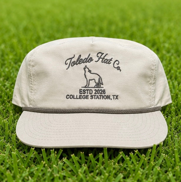 Toledo Hat Co. Sand Dune and Loden Coyote Hat – front view, structured snapback with braided rope brim detail