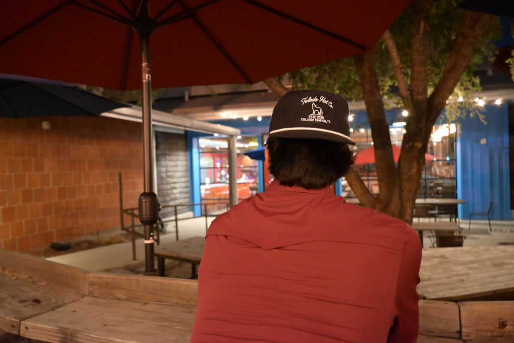 Toledo Hat Co. Black and White Coyote Hat – lifestyle shot outdoors