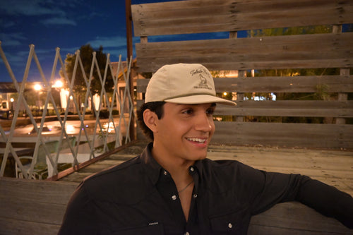 Toledo Hat Co. Sand Dune and Loden Coyote Hat – lifestyle shot outdoors