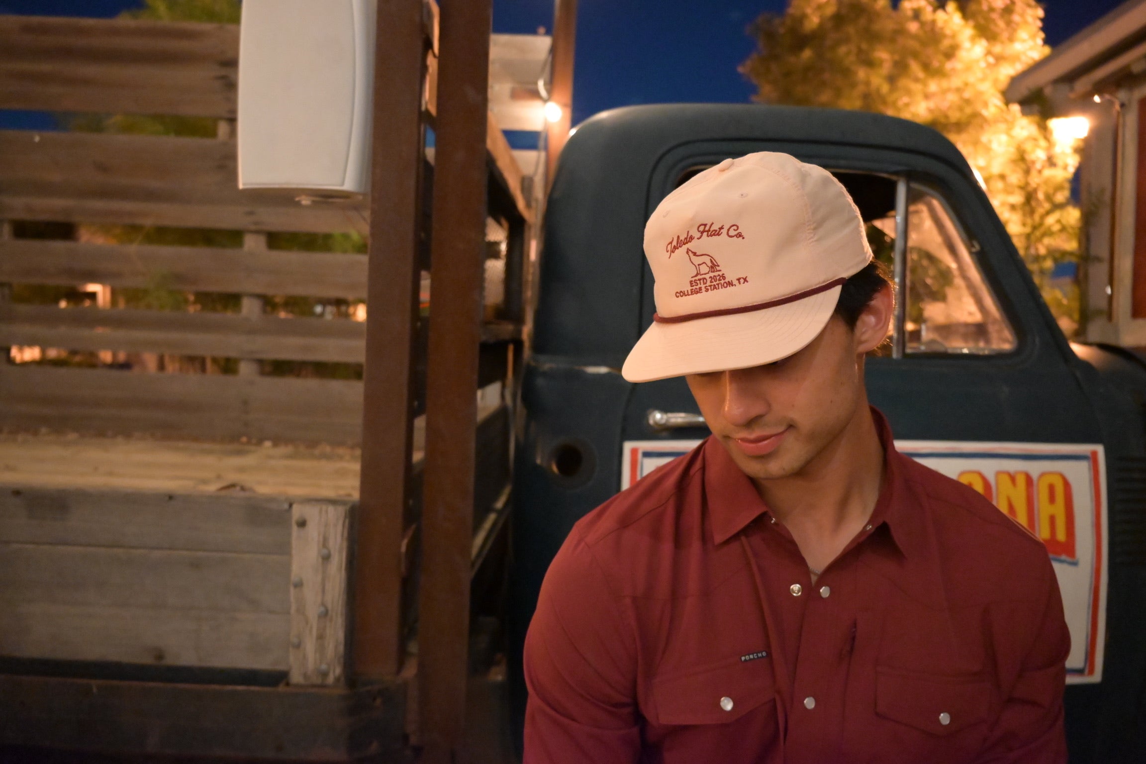 Toledo Hat Co. Pale Peach and Maroon Coyote Hat – lifestyle shot outdoors